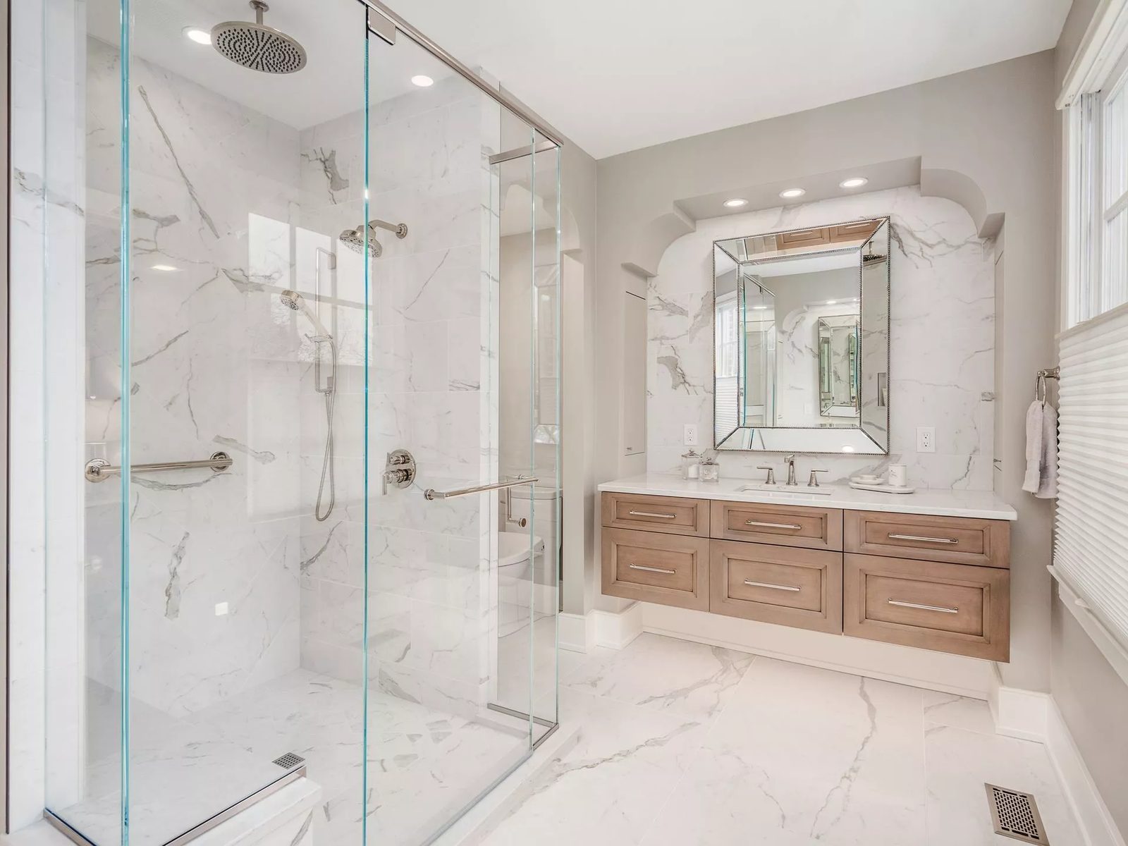 Marble shower and wood vanity design inspiration